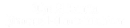 Logo of The Atlanta Journal-Constitution, displaying its name in a white, ornate gothic font on a transparent background.
