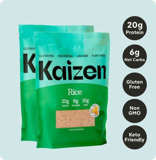 Two turquoise and green Kaizen Food Company Low Carb Rice bags are shown. Labels highlight 20g protein, 6g net carbs, gluten-free, non-GMO, and keto-friendly features, emphasizing high-protein benefits with a low-carb approach to plant-based nutrition.
